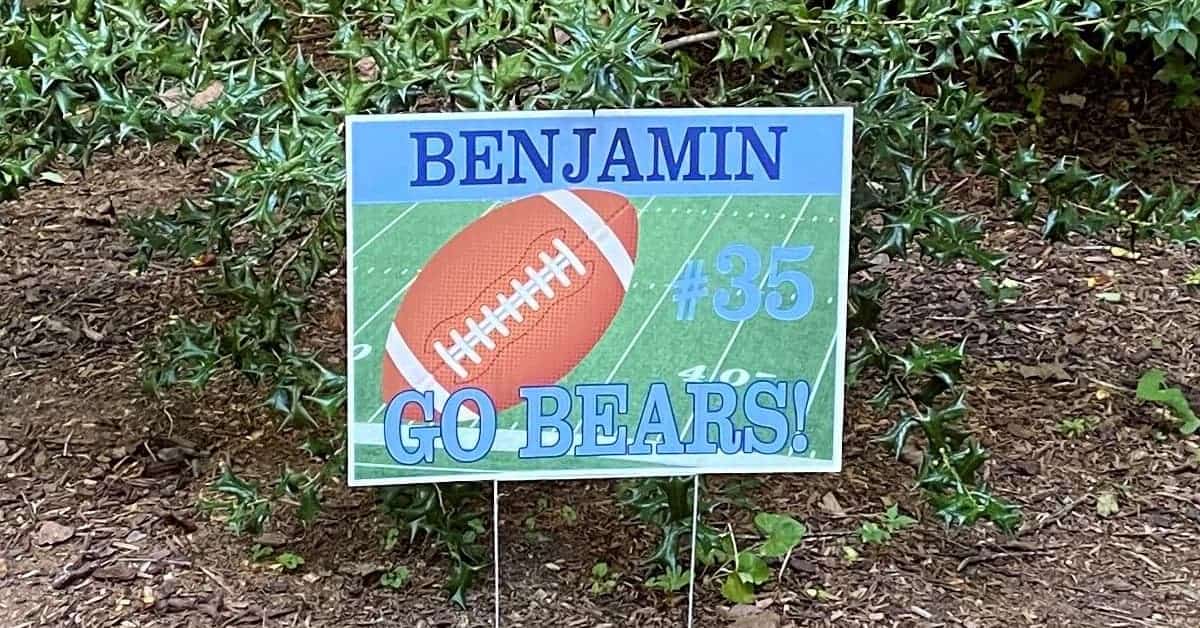 Close-up of a custom sports yard sign supporting a local soccer team, crafted with durable materials and full-color printing that captures the team’s logo and colors vividly, perfect for community support and event directions.